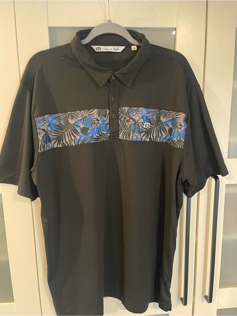 Travis Mathew Black Polo with Blue Floral Chest Band